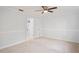 The bedroom has neutral carpet, white walls, and an entry way to another room at 8204 Reynolds Dr, Hudson, FL 34667