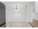 Open dining area with modern lighting and tile floors at 8204 Reynolds Dr, Hudson, FL 34667