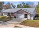 Charming single-Gathering home with a well-manicured lawn, a two-car garage, and a welcoming driveway at 8204 Reynolds Dr, Hudson, FL 34667