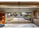 View from inside the garage to the houses across the street via an open garage door at 8204 Reynolds Dr, Hudson, FL 34667