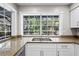 Well lit kitchen with new cabinets, granite countertops and stainless steel appliances at 8204 Reynolds Dr, Hudson, FL 34667