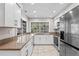 Well lit kitchen with new cabinets, granite countertops and stainless steel appliances at 8204 Reynolds Dr, Hudson, FL 34667