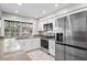Well lit kitchen with new cabinets, granite countertops and stainless steel appliances at 8204 Reynolds Dr, Hudson, FL 34667