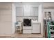 Well-organized laundry room equipped with washer, dryer, sink, and ample storage space at 8204 Reynolds Dr, Hudson, FL 34667