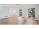Bright living room features new laminate flooring, fresh neutral paint, and an abundance of natural light at 8204 Reynolds Dr, Hudson, FL 34667