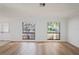 Bright living room features new laminate flooring, fresh neutral paint, and an abundance of natural light at 8204 Reynolds Dr, Hudson, FL 34667