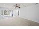 Open living area with new carpet and French door access to the back yard at 8204 Reynolds Dr, Hudson, FL 34667
