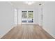 Bright living room features new laminate flooring and French doors at 8204 Reynolds Dr, Hudson, FL 34667