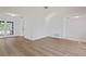 Bright living room features new laminate flooring, fresh neutral paint, and an abundance of natural light at 8204 Reynolds Dr, Hudson, FL 34667