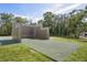 Outdoor racquetball court bordered by green grass and mature trees in a vibrant community park at 8204 Reynolds Dr, Hudson, FL 34667
