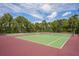 Outdoor tennis courts available for residents, set against a backdrop of lush greenery and blue skies at 8204 Reynolds Dr, Hudson, FL 34667