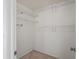 This walk-in closet features neutral carpet and metal shelving, offering ample storage space at 8204 Reynolds Dr, Hudson, FL 34667