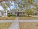 Beautiful home with a cozy front porch, surrounded by lush landscaping and mature trees at 914 S Bruce St, Tampa, FL 33606