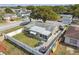 Aerial view of a home with a fenced backyard, patio, and lush greenery at 9201 Lunar Ln, Port Richey, FL 34668