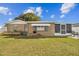 Backyard of single-story house showing the lawn, garden, and patio at 9201 Lunar Ln, Port Richey, FL 34668