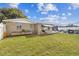 Expansive backyard featuring a green lawn and outdoor dining, plus a barbecue area at 9201 Lunar Ln, Port Richey, FL 34668