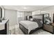 A cozy bedroom features a modern bed frame with decorative bedding, complementing the white tile flooring at 9201 Lunar Ln, Port Richey, FL 34668