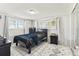 Bright bedroom with two windows, a queen bed, tile floor and complementary furniture for a comfortable stay at 9201 Lunar Ln, Port Richey, FL 34668