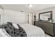 A bright bedroom with a dresser, a closet, stylish bedding and a mirror, perfect for relaxing and unwinding at 9201 Lunar Ln, Port Richey, FL 34668
