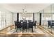 Elegant dining room with a large table, upholstered chairs, and mirrored wall at 9201 Lunar Ln, Port Richey, FL 34668