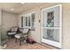 Inviting entryway featuring tiled flooring, comfortable seating, and a decorative glass accent door at 9201 Lunar Ln, Port Richey, FL 34668