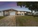 Charming home featuring a paved driveway, well-maintained lawn and mature tree providing nice curb appeal at 9201 Lunar Ln, Port Richey, FL 34668