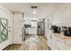 Well-lit kitchen featuring stainless appliances, white cabinets, and an open design at 9201 Lunar Ln, Port Richey, FL 34668