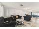 Charming living room featuring stylish black sofa set and decorative mirror-topped coffee table at 9201 Lunar Ln, Port Richey, FL 34668