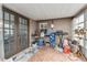 Enclosed sun room with tiled floors, window, and glass doors, offering space for different activities at 9201 Lunar Ln, Port Richey, FL 34668