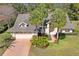 Aerial front view of a well-maintained home with mature landscaping and a two-car garage at 9405 Ashley Dr, Weeki Wachee, FL 34613