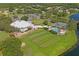 An aerial view of a community clubhouse with a pool, tennis courts, and golf course at 9405 Ashley Dr, Weeki Wachee, FL 34613