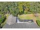 An aerial perspective highlights the screened-in patio attached to the house, nestled amidst lush greenery at 9405 Ashley Dr, Weeki Wachee, FL 34613
