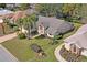 Aerial view showcasing a well-maintained home with palm trees and a manicured lawn at 9405 Ashley Dr, Weeki Wachee, FL 34613