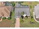 Overhead view of the home showing the roof, backyard, and surrounding landscaping at 9405 Ashley Dr, Weeki Wachee, FL 34613