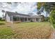 View of the screened lanai and backyard, inviting you to enjoy the beauty of outdoor living and relaxation at 9405 Ashley Dr, Weeki Wachee, FL 34613