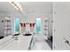 Well-lit bathroom featuring a double sink vanity and shower with colorful curtain at 9405 Ashley Dr, Weeki Wachee, FL 34613