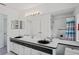 Spacious bathroom features a double sink vanity, large mirror, and a tiled shower at 9405 Ashley Dr, Weeki Wachee, FL 34613