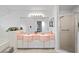 Bright bathroom featuring dual sinks, vanity lights, and a glass enclosed shower at 9405 Ashley Dr, Weeki Wachee, FL 34613