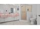 Bathroom featuring dual sinks, vanity lighting, and a glass enclosed shower at 9405 Ashley Dr, Weeki Wachee, FL 34613