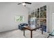 Charming bedroom featuring a custom bookshelf, ample lighting and comfortable seating at 9405 Ashley Dr, Weeki Wachee, FL 34613