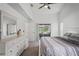 Well-lit bedroom featuring a ceiling fan, neutral paint and carpet flooring at 9405 Ashley Dr, Weeki Wachee, FL 34613