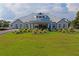 Beautiful clubhouse with manicured lawn featuring arched windows and a covered entryway at 9405 Ashley Dr, Weeki Wachee, FL 34613