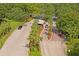 Aerial view of a community entrance with manned security gate, brick-paved streets, and lush landscaping at 9405 Ashley Dr, Weeki Wachee, FL 34613