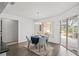 Charming dining area with table set for a meal and sliding glass doors to outdoor space at 9405 Ashley Dr, Weeki Wachee, FL 34613