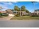 Inviting home with lush lawn, mature landscaping, and a welcoming entrance at 9405 Ashley Dr, Weeki Wachee, FL 34613