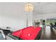 Spacious game room featuring a billiard table under a stylish light fixture and hardwood floors at 9405 Ashley Dr, Weeki Wachee, FL 34613