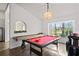 Game room with a pool table and shuffleboard, perfect for entertaining guests at 9405 Ashley Dr, Weeki Wachee, FL 34613