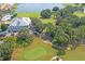 Aerial shot overlooking lush green golf course and clubhouse with lake view at 9405 Ashley Dr, Weeki Wachee, FL 34613