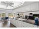 Open-concept kitchen with granite countertops and modern appliances overlooking the dining area and game room at 9405 Ashley Dr, Weeki Wachee, FL 34613