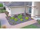 Close-up showcasing the home's landscaping with a tidy mulch bed and decorative plants at 9405 Ashley Dr, Weeki Wachee, FL 34613